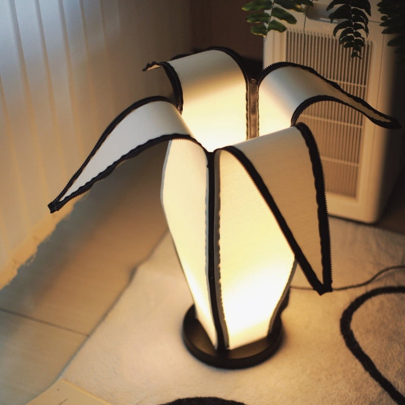 BananaGlow – Justerbar bananformet bordlampe med lynlåsdetaljer